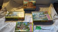 Four FALLER model kits in their original boxes with scenic previews, including one with a thatched roof house and other buildings.