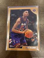 Front of the 1998-99 Topps Tracy McGrady basketball card showing McGrady in Toronto Raptors uniform holding basketball.