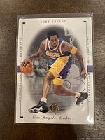 Front of 1998-99 Upper Deck SP Authentic Kobe Bryant basketball card showing player image, Lakers uniform, and printed signature.