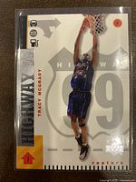 Front of 1998-99 Upper Deck Tracy McGrady Highway 99 basketball card showing player dunking and card branding.