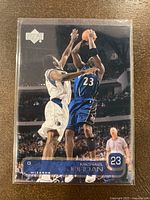 Front of the Michael Jordan basketball card showing him in blue Wizards uniform shooting over an opponent in white.