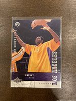 Front view of the Kobe Bryant 2002-03 Upper Deck UD Superstars basketball card showing player in Lakers warm-up clothing.