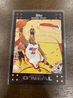 Front side of the 2007-08 Topps Shaquille O'Neal basketball card depicting him dunking in a Miami Heat #32 uniform, protected in a clear sleeve.
