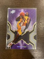 Front of the 2007-08 Upper Deck SPX Kobe Bryant basketball card showing player in Lakers uniform with purple and gold design.