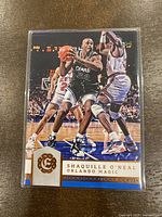 Front image of Shaquille O'Neal basketball card in Orlando Magic uniform, showing card number 184 from 2016-17 Panini Excalibur series