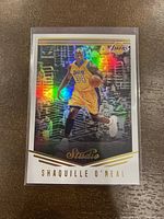 Front of 2016-17 Panini Studio Shaquille O'Neal card showing holographic image of player in Lakers uniform.