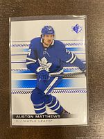 Front of 2019-20 Upper Deck SP hockey card showing Auston Matthews in Toronto Maple Leafs uniform with blue parallel design.