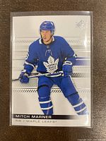 Front image of Mitch Marner hockey card showing player in Toronto Maple Leafs blue uniform.