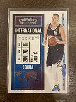 Front of the basketball card showing Nikola Jokic in Serbia uniform with 'International Ticket' design.