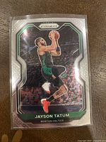 Front photo of the Jayson Tatum basketball card showing the player in Celtics green uniform mid-jump shot, with Prizm silver design and card details.