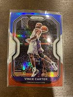 Red White Blue holographic Panini Prizm Vince Carter card depicting a basketball dunk for the Toronto Raptors.
