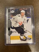 Front side of the 2020-21 Upper Deck Connor McDavid hockey card showing Connor in all-star jersey skating on ice.