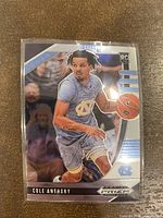 Front photo of 2020 Panini Prizm Cole Anthony rookie basketball card showing player in action with UNC uniform and rookie card logo.