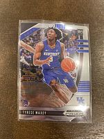 Front view of 2020 Panini Prizm Tyrese Maxey Rookie Card shows player in action with shiny prizm effect and RC logo.