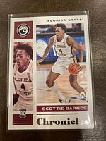 Front of 2021 Panini Chronicles Scottie Barnes Rookie Basketball Card showing action photo and player's name.