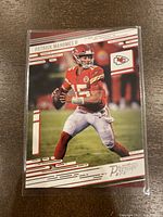 Front of the 2021 Panini Prestige Patrick Mahomes football card showing player in action with red and white design and Chiefs logo.