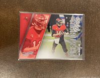 Front image of 2021 Panini Prestige Prestigious Pros Tom Brady football card showing dual images of the player in Buccaneers red and black uniform and branded text "Prestigious Pros".