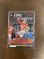 Front view of the 2021 Panini Prestige Time Stamped Patrick Mahomes insert card showing action shot and time stamped graphic.