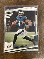 Front view of Jalen Hurts football card showing player in Eagles uniform with logos and card number 234.