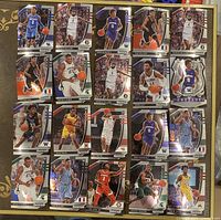 Top down image showing all 20 assorted 2020 Panini Prizm basketball rookie cards laid out in a grid on flat surface.