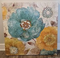 Front view of extra large floral canvas print featuring turquoise, yellow, gold, and cream flowers on rustic textured background.