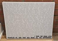 Close-up showing upper portion of poem text in green and black on pale grey background.