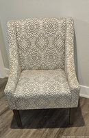 Front view of the Wayfair occasional chair showing the grey and cream geometric upholstery and tapered legs.