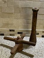 Lot showing both the wooden stringhopper maker and textile mill spool bobbin spindle side by side on a granite countertop against a tiled backsplash.