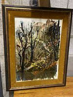 Full view of the framed abstract landscape painting with yellow mat and wood frame.