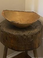 Side angle of the maple wood bowl showing natural bark edge on rim and smooth interior.