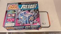 Photo of the boxed Metal Modeler Diecast Factory toy casting kit showing the front of the packaging and artwork.
