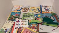 Overview of the twelve French children's books including the large felt animal book and other picture books.