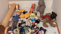 Photo showing collection of toys including Blippi plush, wooden dog pull toy, signing robot and several plush animals