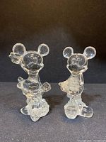Front view of the pair of crystal Mickey and Minnie Mouse figurines on a black background.