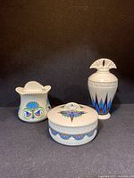 All three porcelain pieces together showing their relative sizes and designs.