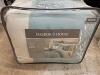 Front view of the packed Harbor House Coastline bed set in zippered bag showing brand and set info