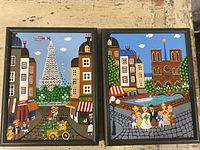 Both paintings side by side showing Eiffel Tower and Notre Dame scenes