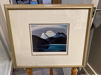 Framed lithograph showing the entire artwork, frame, and matting with clear signs of being a lithograph with signature and numbering.