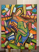 Full view of the abstract acrylic and marker painting, showing a colorful human figure with bold patterns and multiple colors on canvas with signature visible.