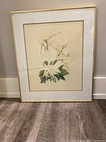 Full framed Chinese wall art showing embossed chrysanthemum flowers with green leaves and yellow branches.