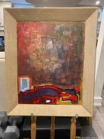 Full view of vintage abstract painting framed in beige matte frame showing textured brushwork and bold color areas.