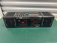 Front view of the Pulser stereo receiver showing dual cassette players, AM-FM radio tuner, speakers, and control panel.