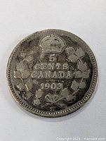 Reverse side of coin showing denomination '5 CENTS CANADA 1903' with maple leaf design and crown.