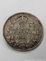Front side of the 1919 Canada silver five cent coin showing denomination, date, crown, and laurel wreath.