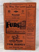 Front cover showing orange cloth with printed local business ads and cover design