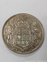 Obverse side of 1941 Canadian silver half dollar with coat of arms and date.
