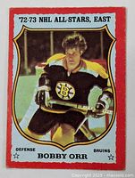 Front of vintage 1973-74 OPC Bobby Orr hockey card showing player in Boston Bruins uniform with red border and '72-73 NHL All-Stars East' title.