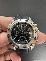 Front angled view showing the stainless steel bezel with timing markers and black dial with three subdials and date window.