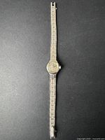 Full view of the vintage women's Caravelle watch showing its full length metal band and watch face.