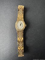 Full view of the gold-tone women's Cardinal watch showing textured bracelet and case design